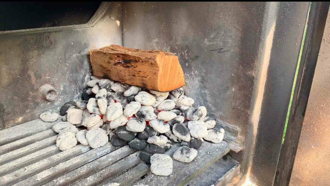 split of wood on a pile of burning charcoal