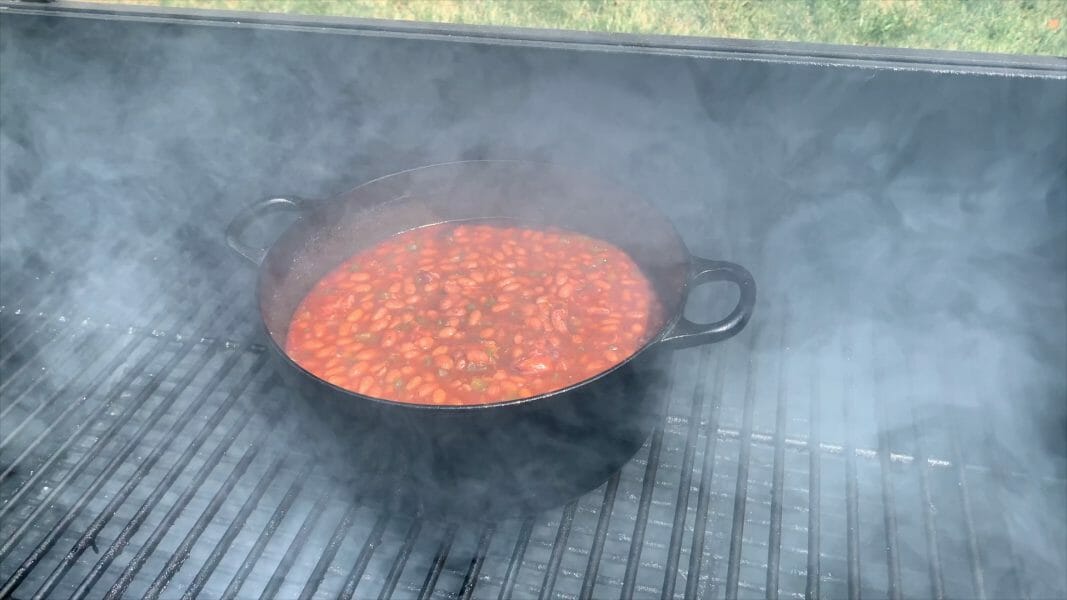 dutch oven of baked beans on the smoker