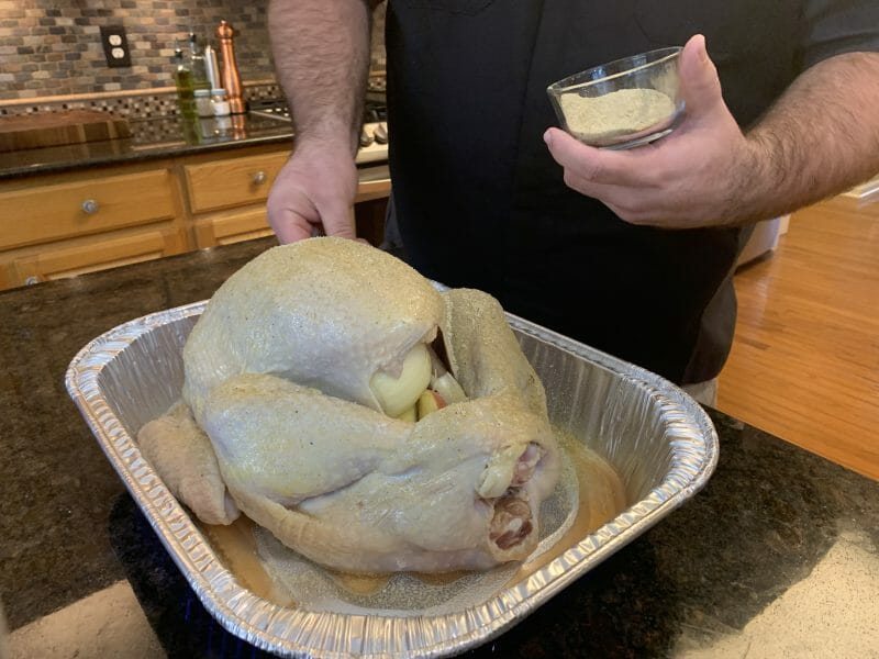 seasoning turkey with turkey rub