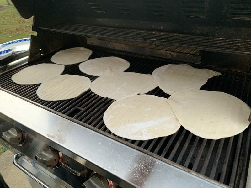 8 rounds of pizza dough on the grill