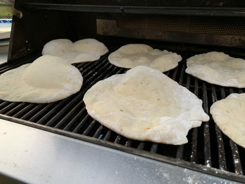 pizza crusts puffed up on the grill