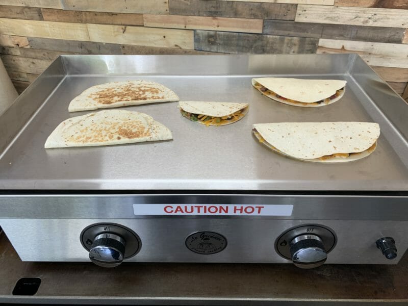 quesadillas cooking on the stainless steel cooking surface  of Le Griddle