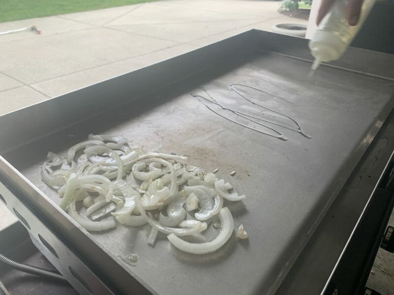 cooking onions on the stainless steel griddle