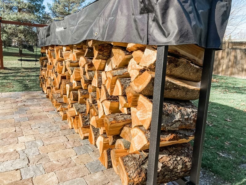 down low view of the 12 foot Woodhaven firewood rack loaded with cherry wood splits