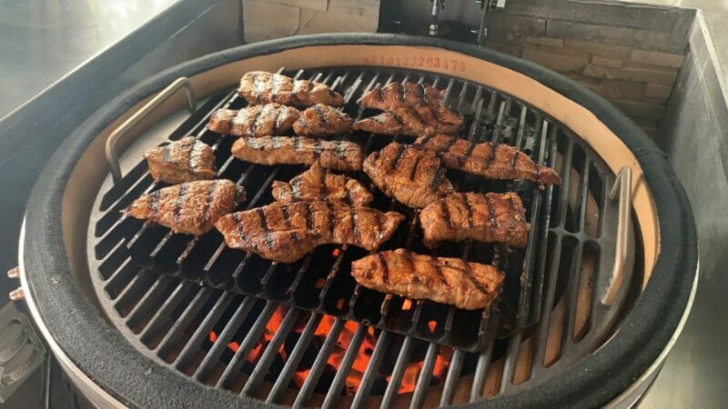 Food cooking on GrillGrates on the Vision Kamado