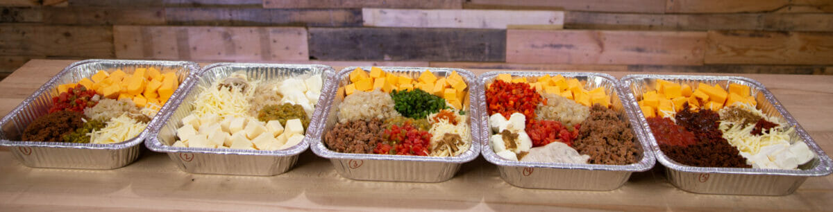 smoked queso dip ingredients in a foil pan