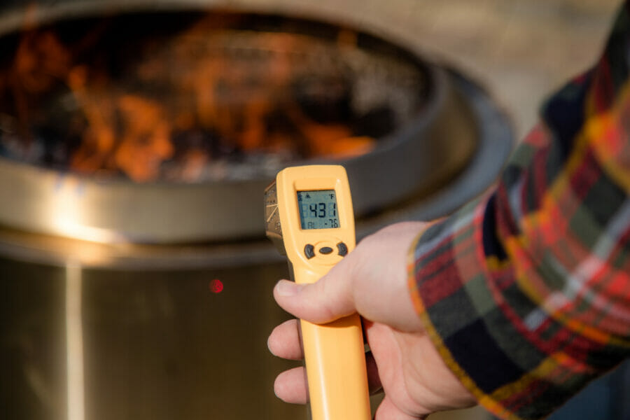 Infrared thermometer reading the temperature of the outside of the Solo Stove Yukon