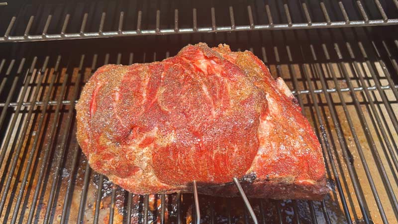 meat probes in a salt and pepper seasoned pork butt smoked on Z Grills wood pellet grill