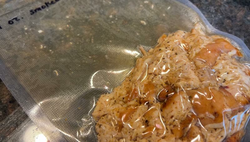 sliced smoked chicken breast being vacuum sealed