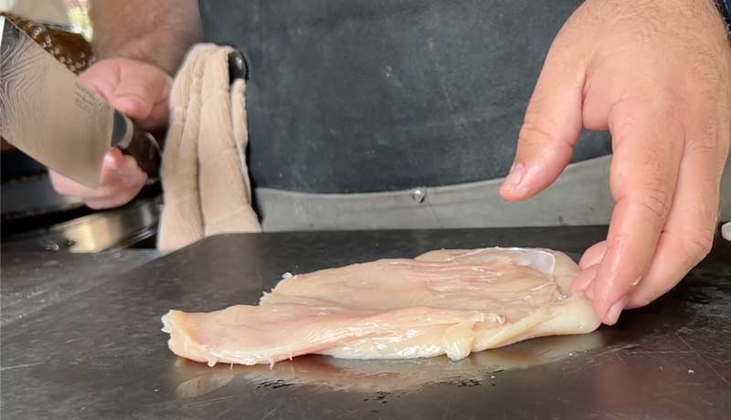 chicken breasts being filleted to make huli huli chicken