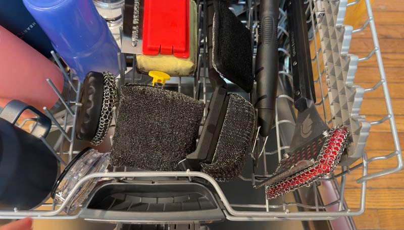 several different styles of grill brushes being cleaned in the dishwasher
