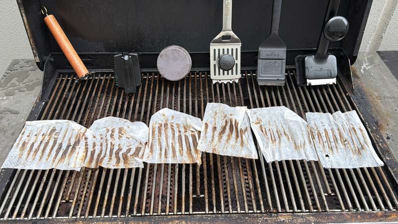using a wipe to see how much residue was left behind by each grill brush