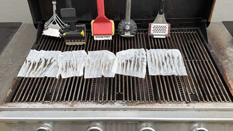 using a wipe to see how much residue was left behind by each grill brush