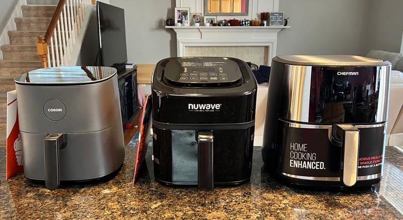 3 air fryers lined up on our kitchen counter