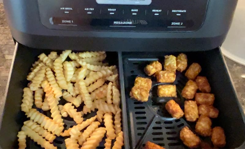 Dual zone air frying frozen french fries and tator tots in the Ninja Foodi air fryer