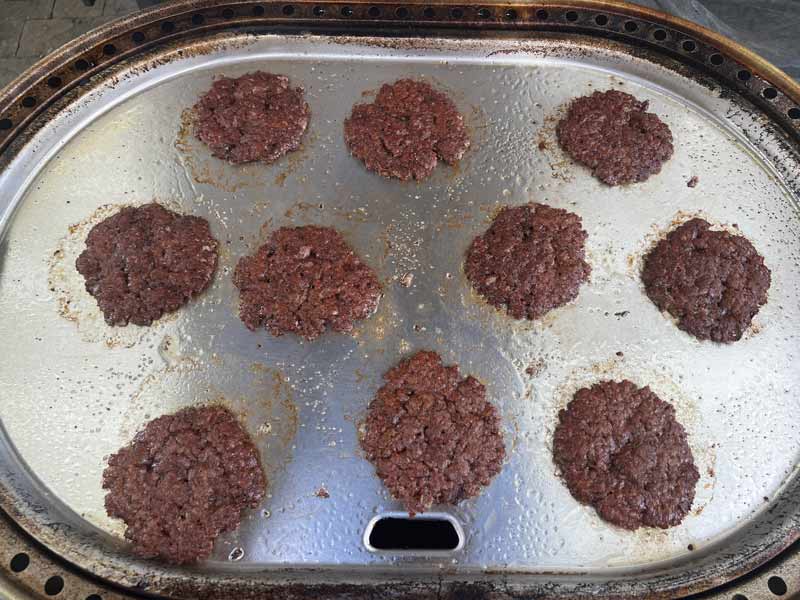 Smashburgers Ten 3 oz. smash burgers cooking on the Solo Stove Steelfire griddle