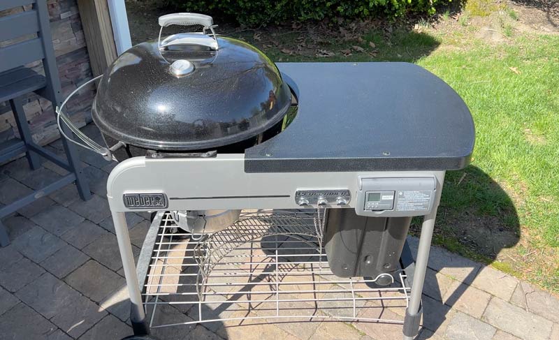 this weber charcoal grill has an incredible amount of prep space on this side shelf