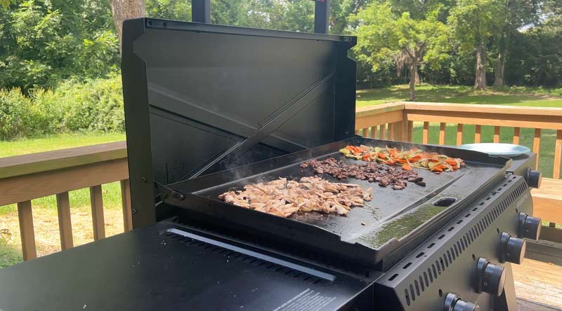 hibachi vegetables and proteins cooking on 2 different heat zones