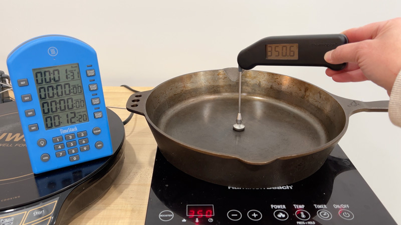 350-test thermometer placed on the cooking surface of a cast iron pan on each induction cooktop