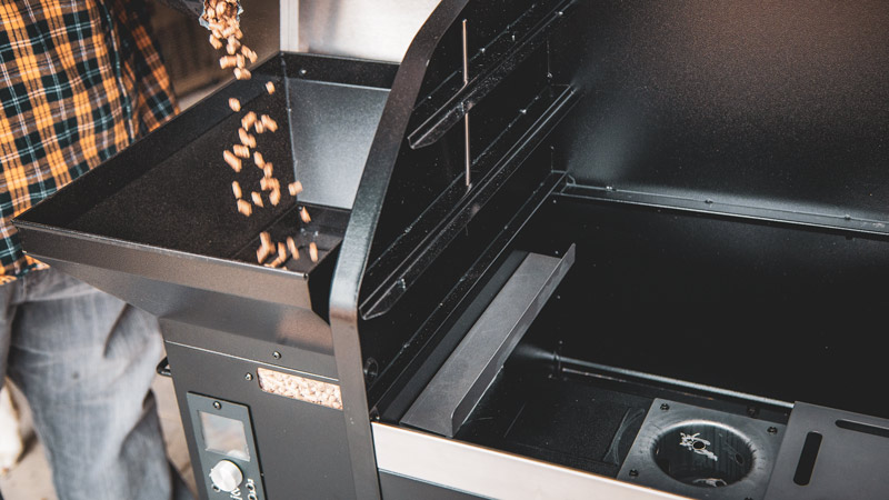 pellet-grill-101a-web filling a pellet grill hopper with wood pellets