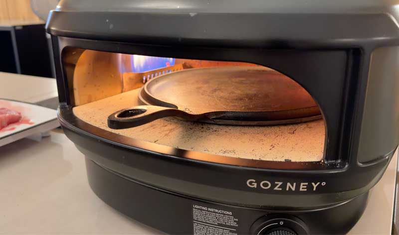 smithey-preheat cast iron pan preheating in the pizza oven