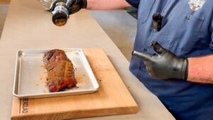 adding more dry rub to the ribs during the final stage of cooking
