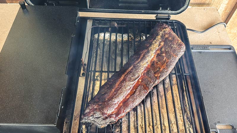 barbecue ribs smoking over indirect heat