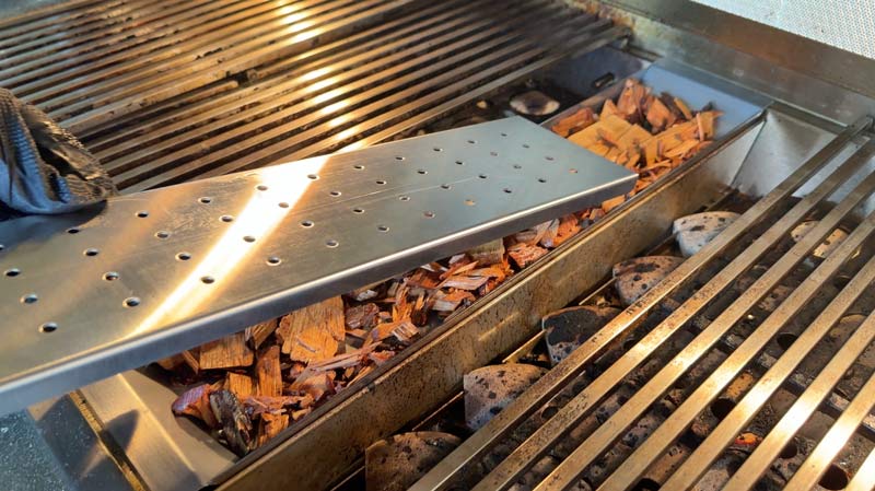 The RCS Cutlass Elite outdoor kitchen grill includes a smoke tray for smoking wood chips.