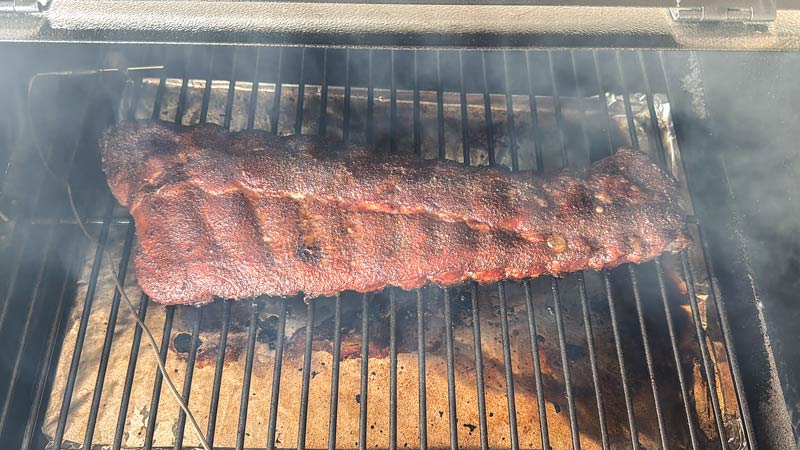 barbecue ribs smoking over indirect heat
