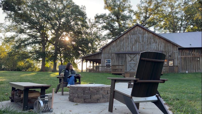 Melissa enjoying her morning coffee sitting by the new DIY fire pit