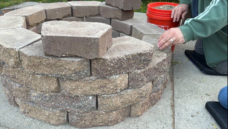 adding paver base between the layers of rock as needed