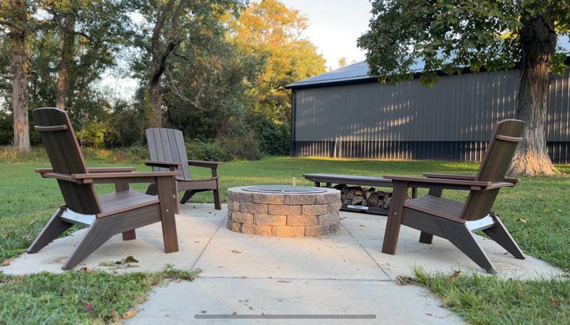 adirondack chairs surrounding the freshly assembled fire pit surround