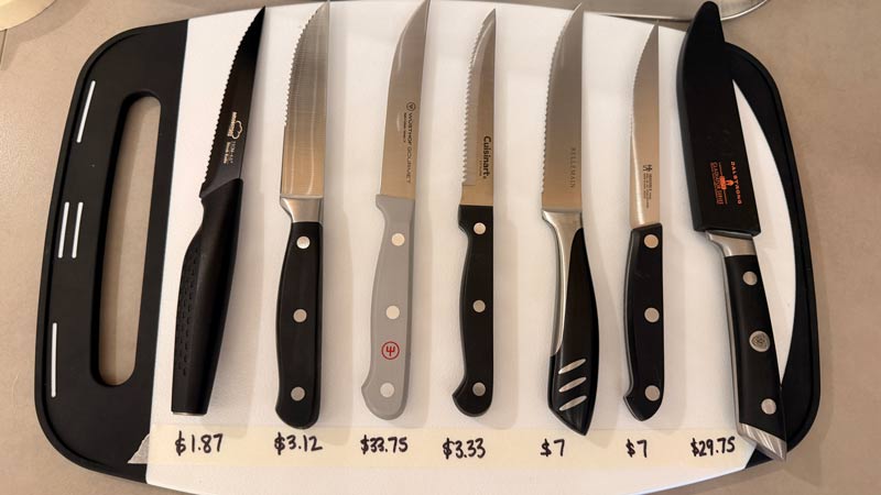 7 steak knives on a cutting board with the price per knife listed